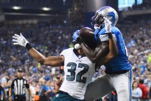 Retired Lions receiver Calvin Johnson hauls in a touchdown over Eagles corner Eric Rowe during last year's Thanksgiving Day game.